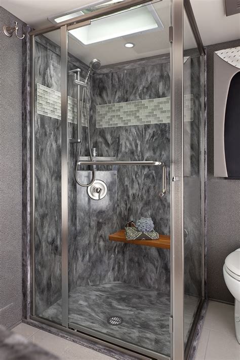 Mystera solid surface shower walls, vanity top and sink in a residential bathroom. Polished solid surface shower walls with decorative subway ...