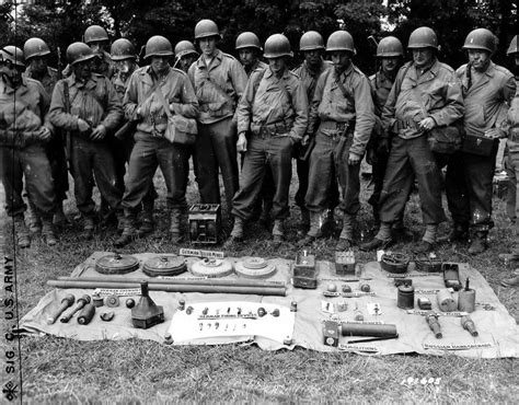 American Soldiers Posing Behind A Number Of Mines Grenades And Other