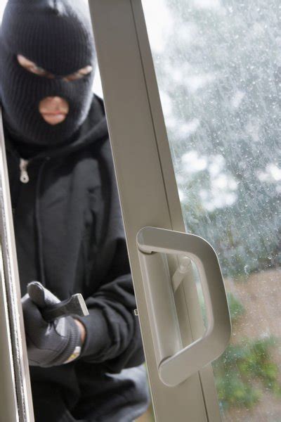 Burglar Breaking Into House — Stock Photo © Londondeposit 21799447