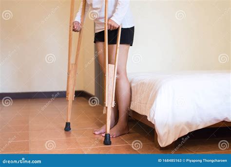 Woman Patient Using Crutches And Broken Leg For Walking In Bedroom
