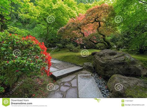 Japanese Garden Strolling Stone Path With Manicured Plants And Trees