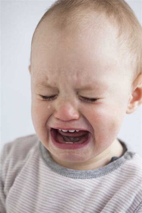 Portrait Of Crying Baby Girl Stock Photo