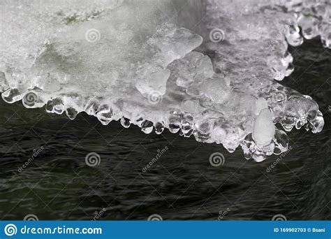 Mountain Cold Stream And Figured Ice Crust In Winter Stock Image