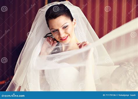 Shy And Thoughtful Bride During A Wedding Preparations Stock Photo