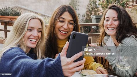Multiracial Girls Having Fun Together In The City While Taking Selfie With Mobile Phone Main