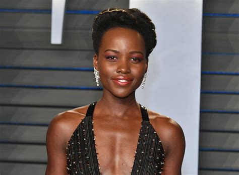 Lupita Nyong O Of Black Panther Fame Glows In The Sun As She Poses In Black And Red Netted Dress