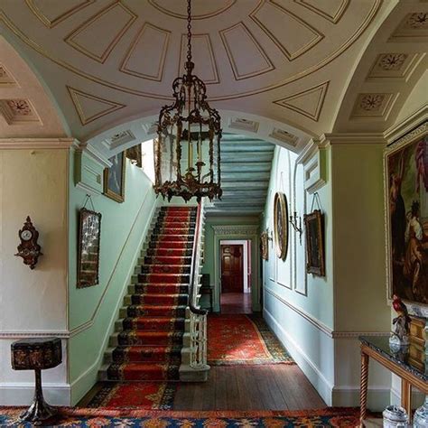 An Ornate Staircase Leads Up To The Second Floor In This House With