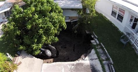 Sinkholes Swallow Womans Car Threaten Homes