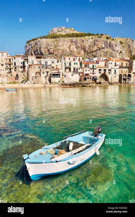 Fishing Boat And Medieval Houses Of Cefalu Old Town Sicily Italy