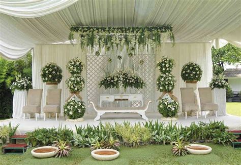 An Outdoor Wedding Setup With Flowers And Greenery