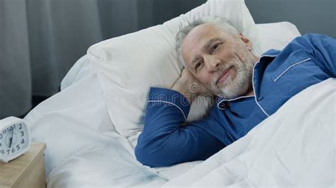 Retired Man Waking Up Active And Full Of Energy After Comfortable
