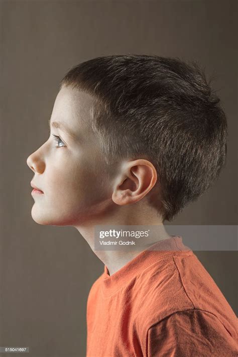 Profile Shot Of Boy Looking Away Over Colored Background High Res Stock