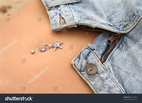 Close Up Of Young Woman Abdomen With Open Jeans And Bellybutton