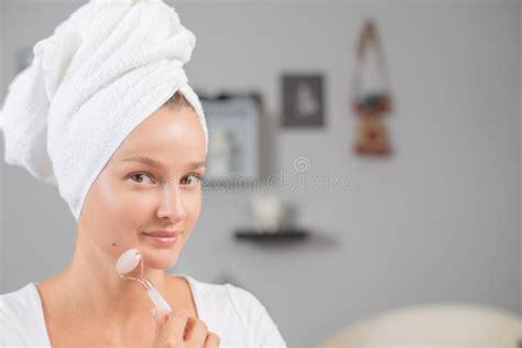 Face Massage Beautiful Woman Is Getting Massage Face Using Jade Facial Roller For Skin Care