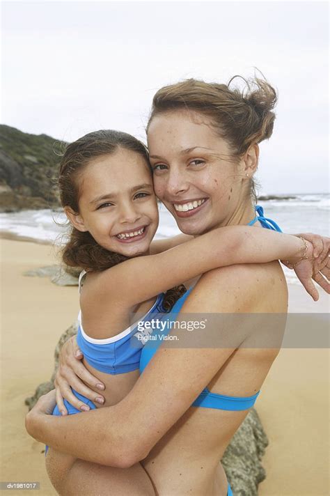Mother Carrying Daughter On A Beach Photo Getty Images