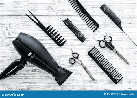Set Of Professional Hairdresser Tools With Combs Gray Wooden Background