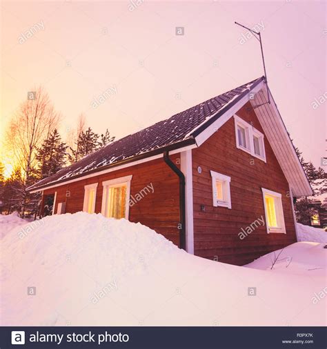 A Cozy Wooden Cabin Cottage Chalet House Covered In Snow Near Ski