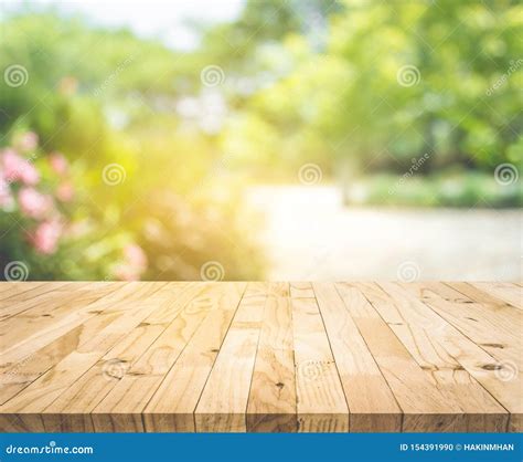 Empty Wood Table Top On Blur Abstract Green From Garden And Home Area