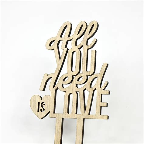 A Wooden Sign With The Words All You Need Is Love And A Heart On It