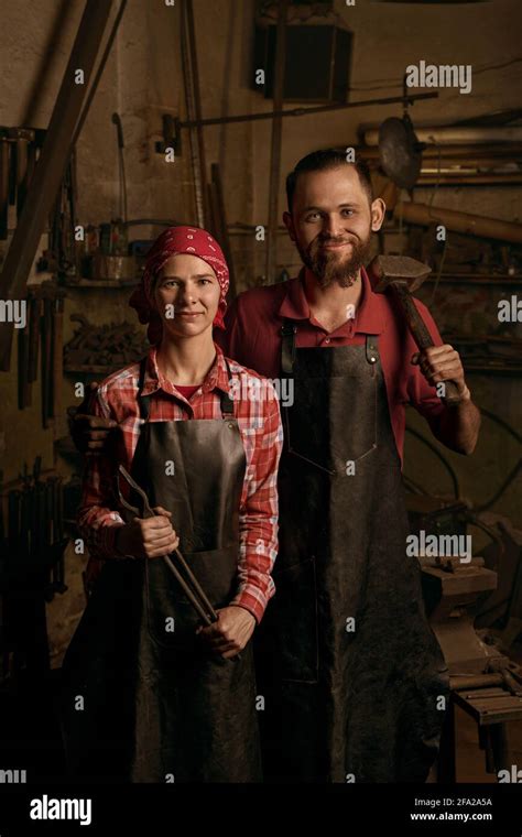 Blacksmiths Couple With Tools In Smithy Portrait Stock Photo Alamy