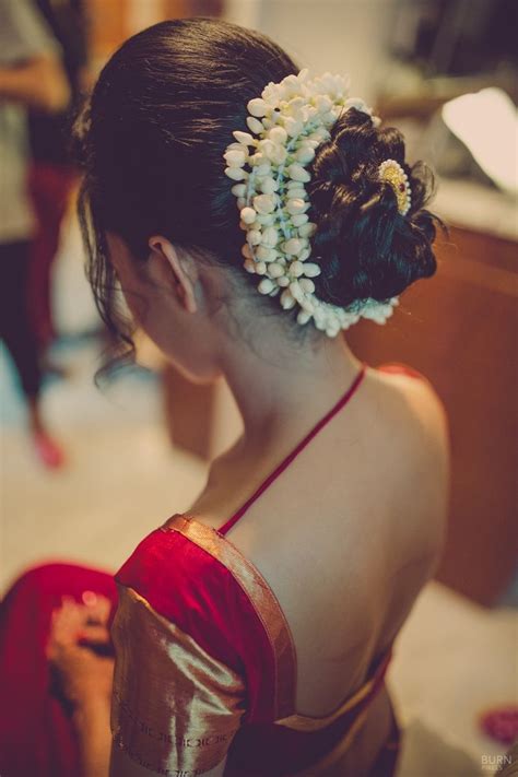 One vital aspect of this process is hair styling. Mogra flowers encase her bridal bun in a traditional style ...