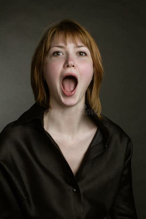 Portrait Of Redheaded Screaming Girls With Mouth Wide Open Stock Photo
