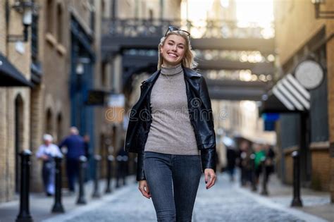 Portrait Of A Beautiful Blonde Urban Woman Walking In The City Stock