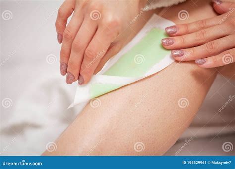Beautician Waxing A Woman S Leg Applying Wax Strip Stock Image Image