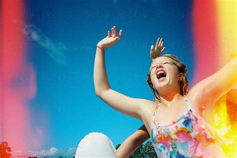 Girl Jumping In Swim Suit In Front Of Blue Sky With Light Leak On Film Del Colaborador De
