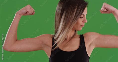 Athletic Caucasian Female Flexing Biceps For Camera On Green Screen