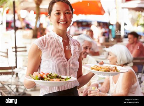 Waitress Serving Food At Outdoor Restaurant Stock Photo Alamy