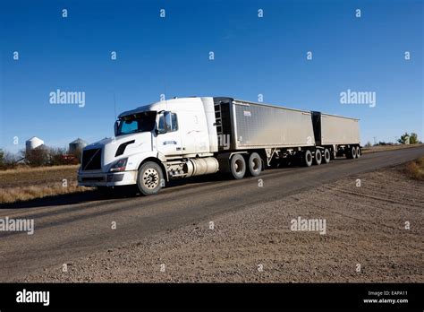 Semi Truck Towing Double Trailer Along Highway In Rural Saskatchewan