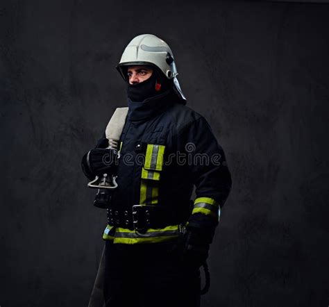 Firefighter In Uniform Holds Fire Hose Stock Image Image Of Fireman