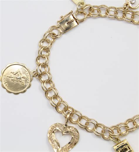 With over 23 lots vintage charm bracelet is set in 14k yellow gold. 14k Yellow Gold Charm Bracelet with Charm Ladies Bracelet