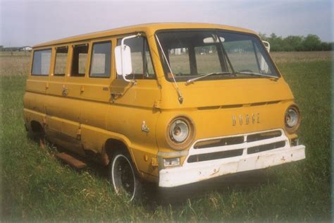An Old Yellow Van Sitting In The Middle Of A Grassy Field With No