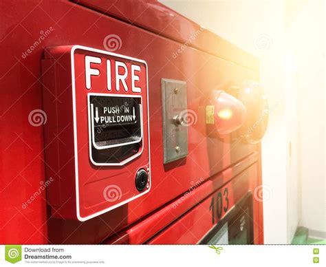 A Hand Reaching And Pulling A Red Fire Alarm Switch Red