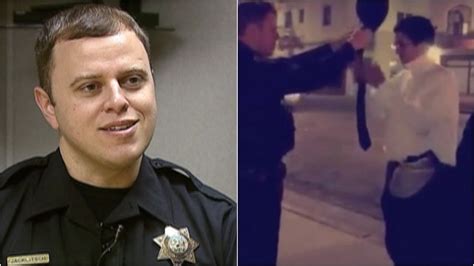Police Officer Helps Student Tie a Tie before Formal