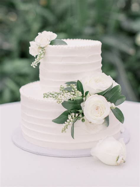 Simple And Elegant White Wedding Cake With White Flowers
