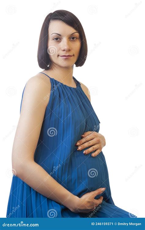 Caucasian Brunette Pregnant Woman In Light Long Blue Dress Posing