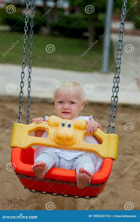 Cute Blond Baby Girl Sitting In A Swing Stock Photo Image Of Outside