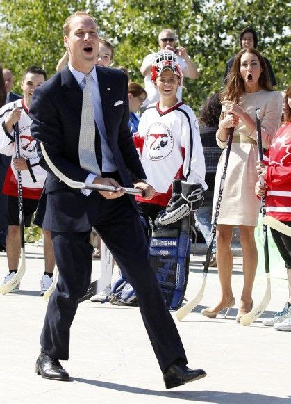 A Man In A Suit And Tie Holding A Hockey Stick While People Watch From The Sidelines