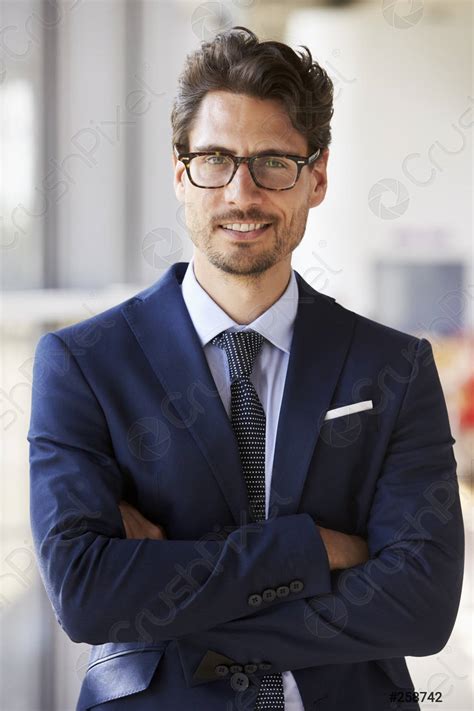 Portrait Of Young Professional Man In Suit Arms Crossed Stock Photo
