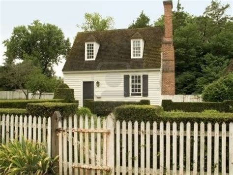A Small Rural Cottage With A White Picket Fence White Picket Fence