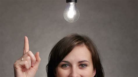 Bulb Lights Up Over A Woman Head When She Gets An Idea Stock Footage