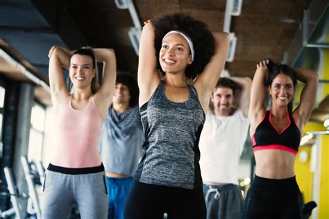 Group Of Healthy Fit People At The Gym Exercising Stock Photo Image