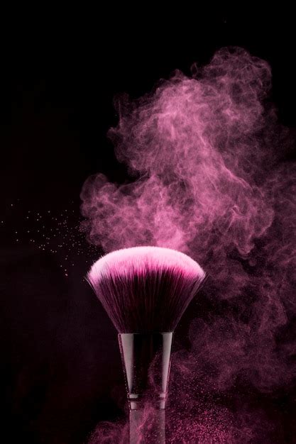 Makeup Brush With Flickering Pink Powder Splash Free Photo