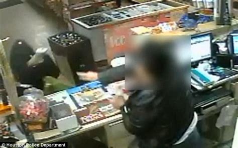 Amazing Moment Heroic Store Clerk Repeatedly Swats Away Robbers Gun Daily Mail Online