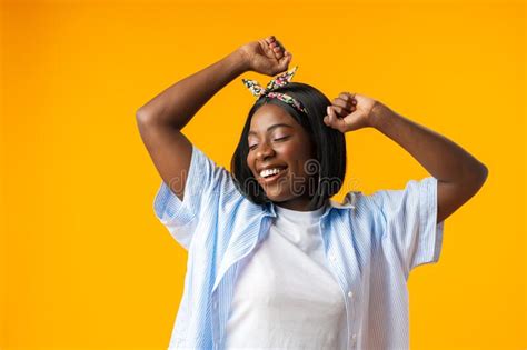 Portrait Of A Cheerful African Woman With Hands Raised On Yellow Background Stock Image Image