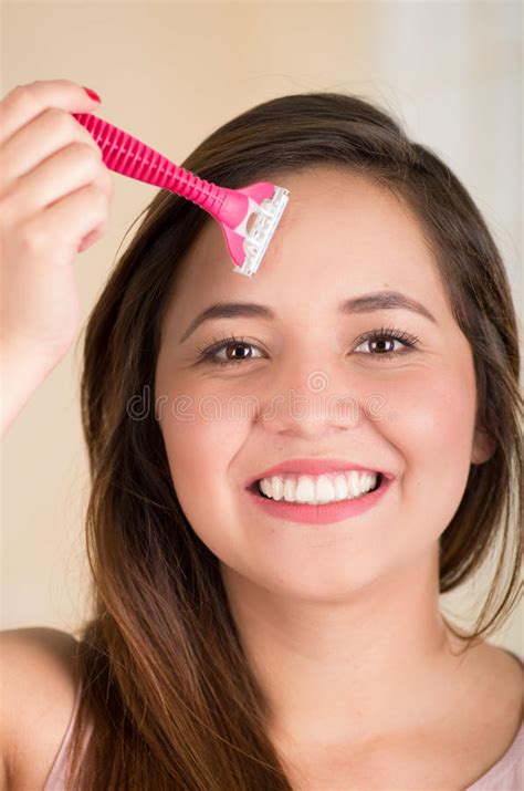 Close Up Of A Beautiful Young Funny Woman With An Shaver On Her Face