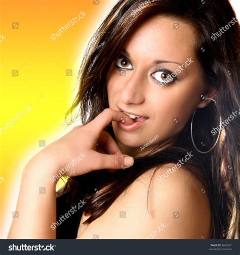 Beautiful Woman With Index Finger In Mouth A Teasing Pose Rendered With Orange Background